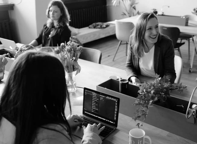 People working with technology in a light and airy room